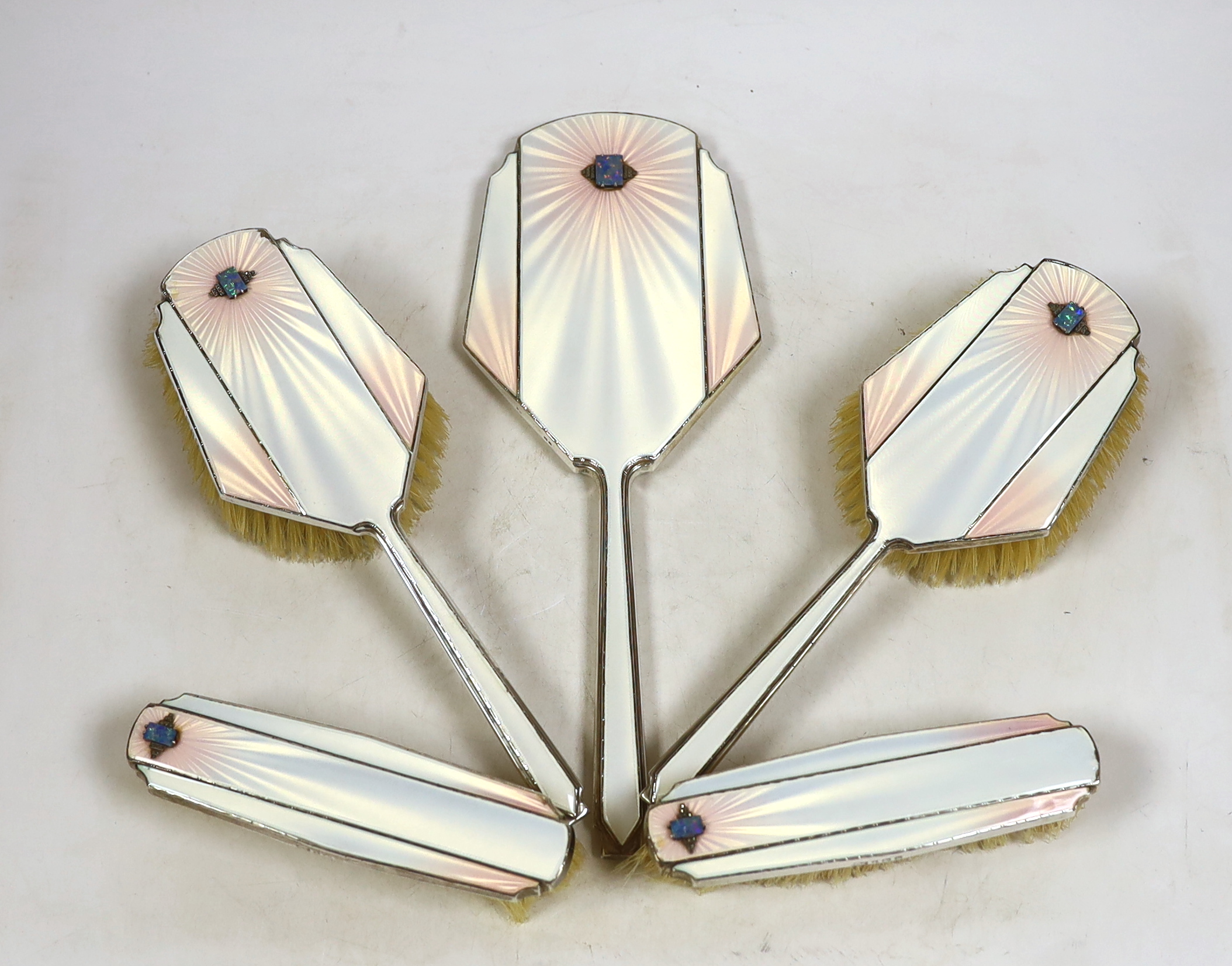 An Art Deco Mappin & Webb silver, enamel, marcasite and black opal mounted six piece mirror, comb (lacking teeth) and brush set, Birmingham, 1935